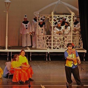 side by side actor with trumpet on stage